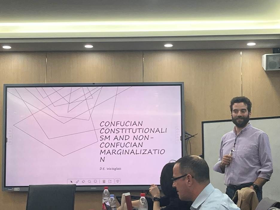 A person standing in front of a projection screenDescription automatically generated A person standing in front of a projection screenDescription automatically generated